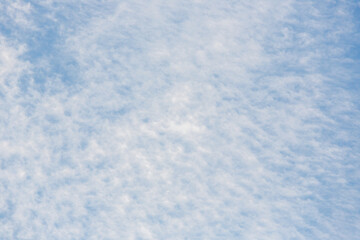 Beautiful clearly deep blue sky with white a little puffy clouds in a sunny day, soft focus.