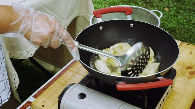 Malaysian Crispy curry puff. Karipap. Street food cooking on portable gas stove. Outdoor cooking