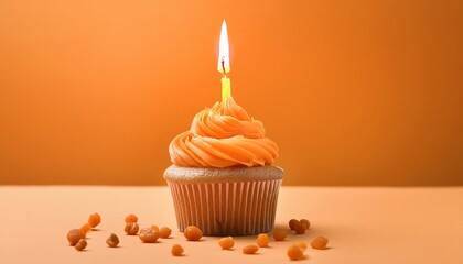 congratulatory orange cupcake with a candle on an orange background. holiday concept and template for postcard
