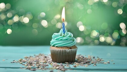 congratulatory green cupcake with a candle on a green background. holiday concept and template for postcard