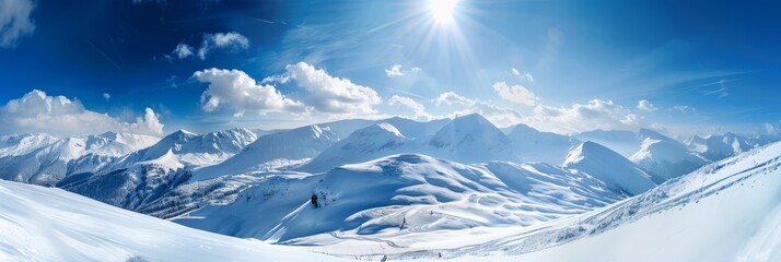 A snowy mountain range under a bright blue sky