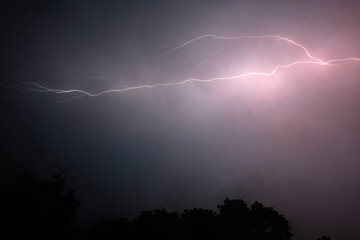 Lightning Storm. A dramatic lightning storm in the night sky with striking lightning bolts.