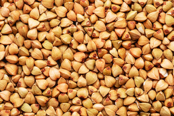 Hulled kernels of buckwheat cereal isolated on white background.