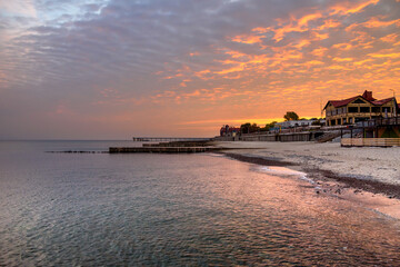 View of sand beach with wooden breakwaters on the Baltic Sea coast on sunrise in Zelenogradsk. Russia