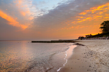 View of sand beach with wooden breakwaters on the Baltic Sea coast on sunrise in Zelenogradsk. Russia