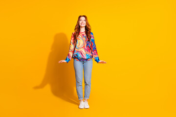 Photo of cheerful cute nice adorable girl wear trendy print clothes news empty space isolated on vivid yellow color background