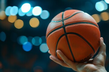 Hand holding basketball in sports arena. Blurred lights in background create focus on ball. Conceptual image capturing sports spirit and determination. Sports stock photo. Generative AI