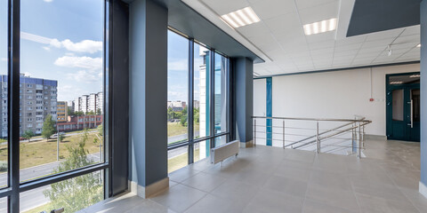 panorama view in empty modern hall with columns, doors and panoramic windows.