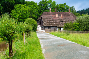 The Old Grandmother's House in Babiccino Valley is a charming historical cottage surrounded by lush greenery, blooming meadows, and the serene Upa River