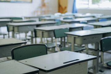 Empty chairs and tables in classroom No people in school classroom