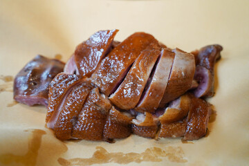 Pot stewed duck. Sliced and presented on a piece of Baking Paper. Traditional and delicious Asian dish. The duck is served pink. Juicy and tender looking meat.