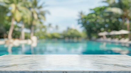 Fototapeta premium Empty white stone marble table and blurred swimming pool in the tropical resort in the summer banner background