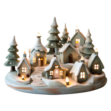 Enchanting miniature Christmas village illuminated with warm lights, featuring snow-covered houses and evergreen trees, creating a festive holiday scene.