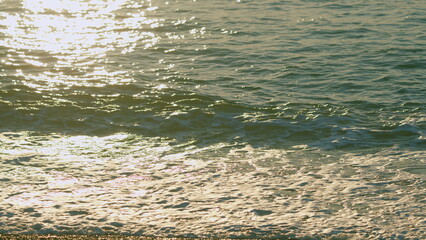 Blue Sea Water Surface With Sparks. Shiny Sparkling Sunlight Reflection In Water With Bokeh Of Sun...
