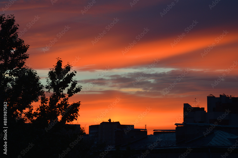 Wall mural Bright sunset over city.