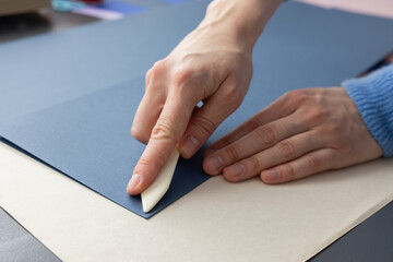 High-quality image of a person binding a book using traditional coptic stitch technique. DIY...