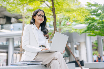 Portrait Indian business women female happy smile. Young Asian success businesswomen happy at green city office park outdoors.