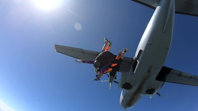 Close-up of a girl making a parachute jump with an instructor