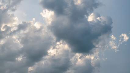 Cumulus sunset clouds with sun setting down.