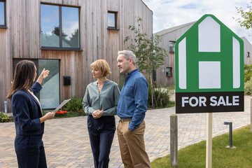 Real estate agent showing a property to a mature couple