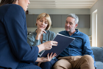 Mature couple meeting with a financial advisor in their home