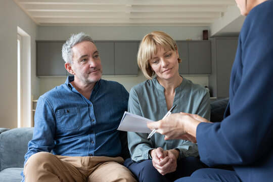 Mature couple meeting with a financial advisor in their home