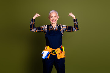 Photo of attractive mature woman professional mechanic show muscles strong dressed blue workwear...