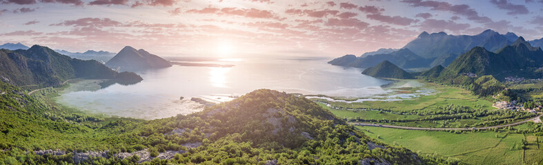 Aerial view of Lake Skadar surrounded by mountains and lush forests in Montenegro