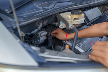 Man's hands repairing car, Car radiator repair, Repair service.