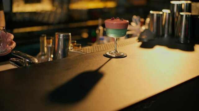 Cocktail with rose on bar counter in restaurant pub Orange drink with juice Fresh prepared alcoholic cooler