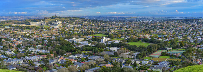 High angle and panoramic view downtown houses and forest seen from Mount Eden at Auckland, New Zealand
