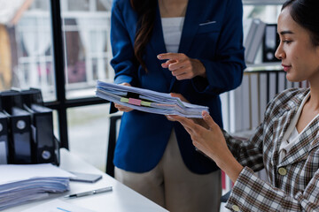 Obraz premium Business financing accounting banking concept. Two Business doing finances and calculate on desk about cost at home office. Businessworking on desk with using calculator, finance accounting.