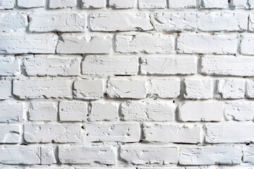Fototapeta premium Close-up of a white brick wall texture background, ideal for construction, interior design, or architectural projects requiring a classic, rustic look.