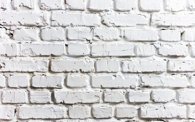 Obraz premium Close-up of a white brick wall with texture and rugged details. Perfect for backgrounds, design, and architectural purposes.