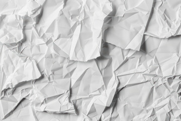 Abstract background featuring a crumpled white paper texture with intricate folds and creases, ideal for design projects and artistic inspiration.