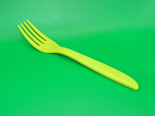 Macro photo of children's educational eating equipment on a green background.