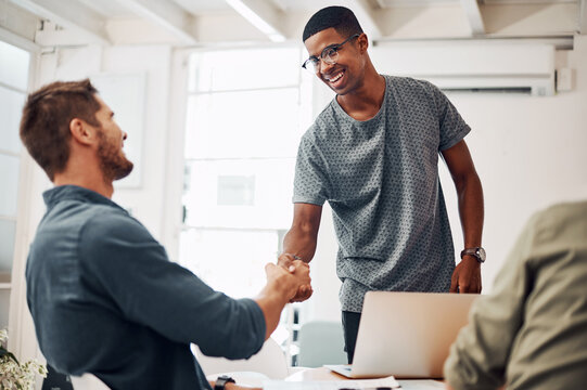 Business people, handshake and welcome to startup tech company with success, onboarding or job interview. Manager shaking hands with young smart programmer for recruitment, opportunity or internship