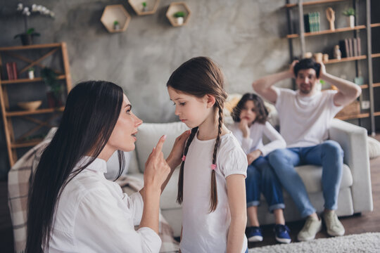 Photo of strict serious mom dad children wear casual outfits getting bad behavior panishment indoors room home house