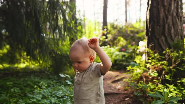 Captivating video of a babys first steps in a forest, exploring nature in 4K resolution, a joyful journey of discovery
