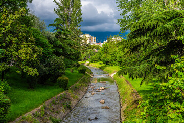 A view down the course of the Tirane river in central Tirana, Albania in summertime
