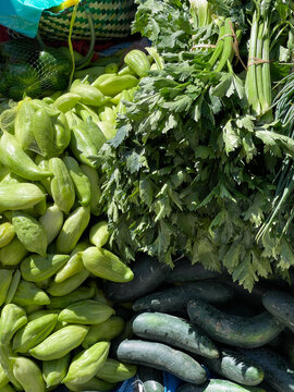 Fresh green vegetables at the market. Achocha, paigua, parsley and cucumber 