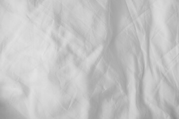 Obraz premium Abstract White Bedding Sheets or White wrinkled fabric background texture and Texture with copy-space :Creased or wrinkled white fabric,Soft focus