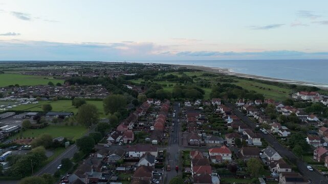 Coastal sunset on the popular seaside holiday resort of Skegness on the east coast of england. Warm summer tones and sweeping vista views.