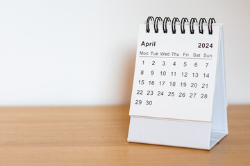 2024 calendar - April month page on the wooden desk