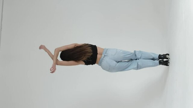 middle-aged woman dancing gracefully in a minimalist studio, arms extended in fluid motion. Concept: Emphasizing the beauty of self-expression and the joy of movement at any age, promoting physical