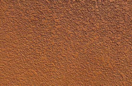 Clay terracotta brown textured paint, rough textured paint on wall, seamless background texture