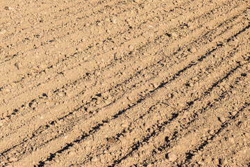Wheel tracks on the soil, close-up of a tractor track