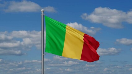 Mali flag waying in the wind against the running clouds on blue sky, close-up flag video