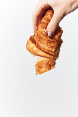 Person holding croissant on white background with copy space