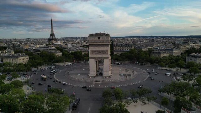 Paris Arc de Triomphe Triumphal Arch at Chaps Elysees at night, Paris, France. Drone view, Eiffel Tower in the background.  Architecture and landmarks of Paris. Postcard of Paris

